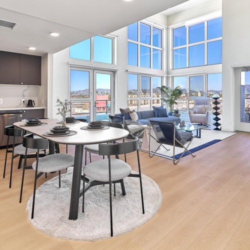 a kitchen and living room with tables and chairs
